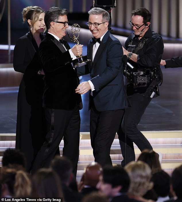 The Late Show with Stephen Colbert has never won at the Emmy Awards. Last Week Tonight with John Oliver is the consistent frontrunner of the category (Pictured: Taylor Tomlinson, Stephen Colbert, and John Oliver at the award ceremony on January 15, 2024)