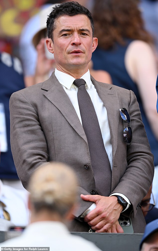 Bloom could be seen watching the match from the stands while sporting a darker tan suit as well as a white dress shirt and patterned tie