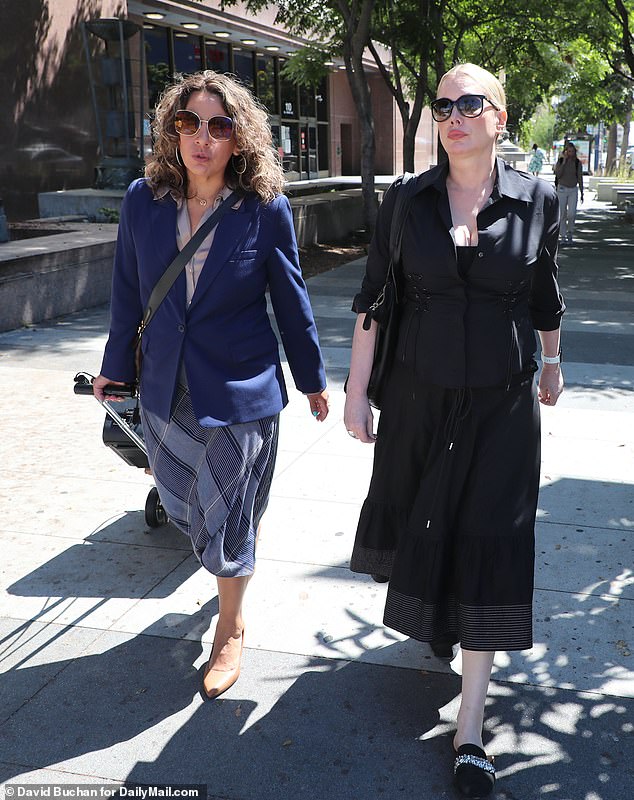Evans, 56 - wearing a black skirt and shirt, black-rimmed glasses and with her blonde-hair tied back - deliberately ignored her Fantastic Four star former husband Wednesday