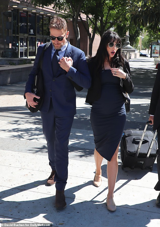 Wallace was noticeably pregnant in a long navy blue dress under a black jacket