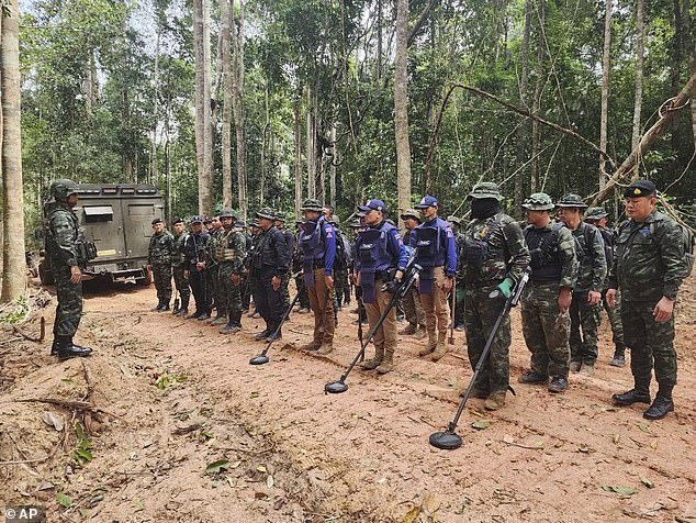 Thai soldiers inspect a border area on Sunday, July 20, 2025, in Ubon Ratchathani province, where the Royal Thai Army said two anti-personnel landmines were found