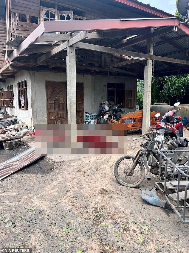 A view shows blood stains in front of a house damaged by a rocket strike, in Surin province, Thailand, July 24, 2025