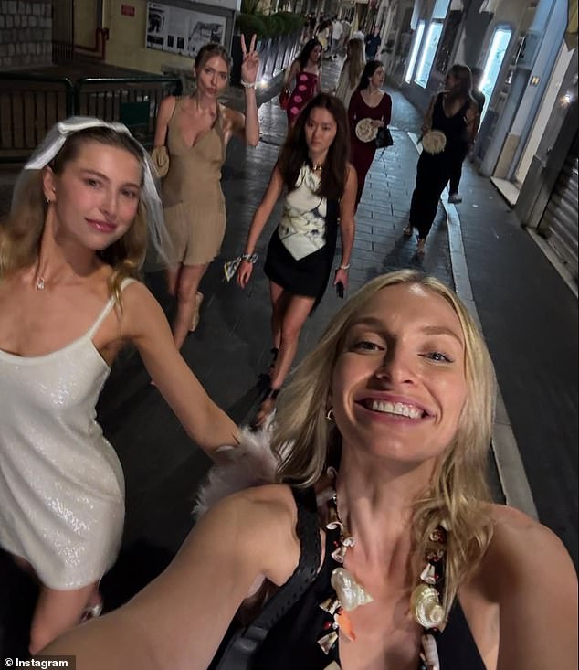Another image from the hen do showed them strutting through the cobbled streets of Capri at night, with Eve leading the way in her veil and glittering white dress
