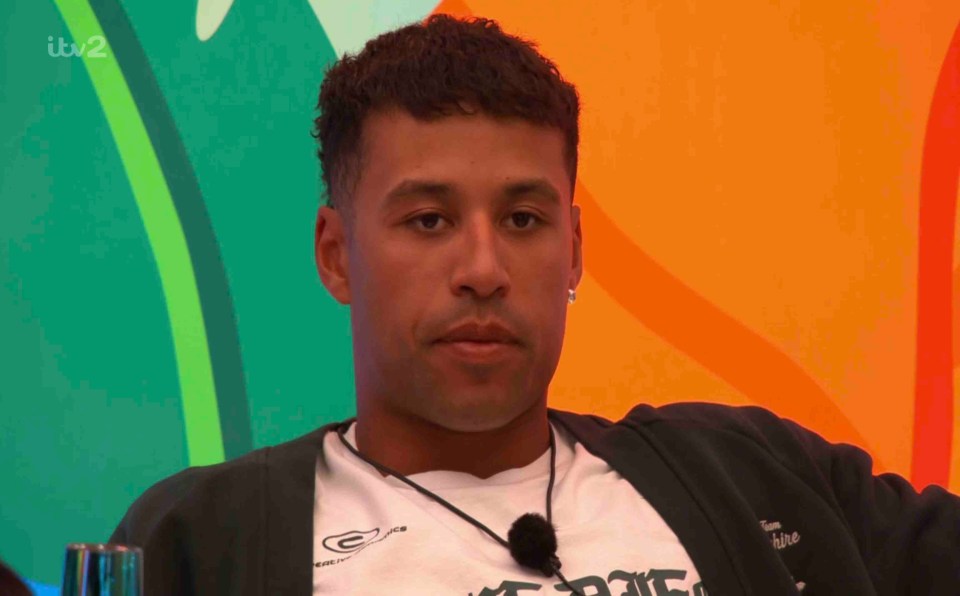 Man sitting in front of an orange and green background.