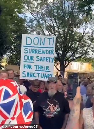 Protesters hold placards up