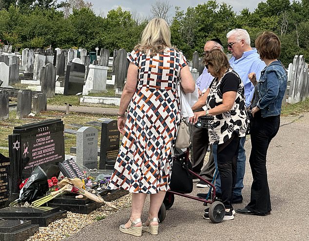 Janis, 70, was aided by a mobility walker, while Mitch, 74, used a walking stick as the pair were comforted by loved ones