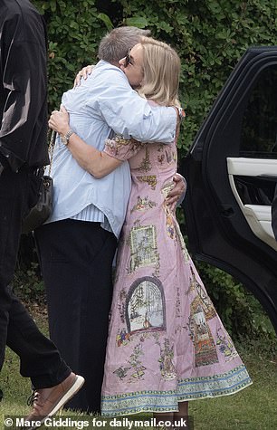 A stylish guest departs the wedding rehearsal before hugging the wedding planner (pictured)
