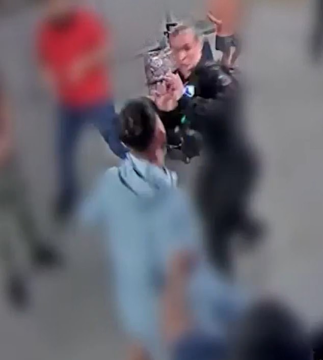 PC Ellie Cook, pictured being confronted by Mohammed Fahir Amaaz, 20, dressed in light blue