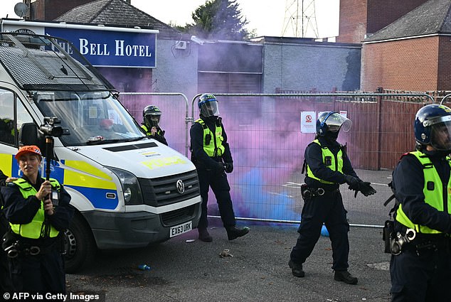 Bottles and smoke flares thrown towards police vehicles outside The Bell Hotel on July 20