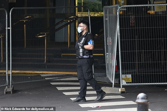 Guards were seen outside the hotel in Canary Wharf, East London, this morning