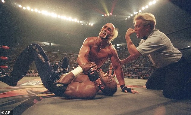 Hogan is seen in action with Karl Malone in 1998