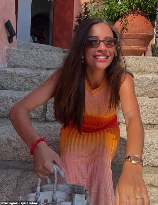Isabel was seen smiling in another photo as she clutched the handbag