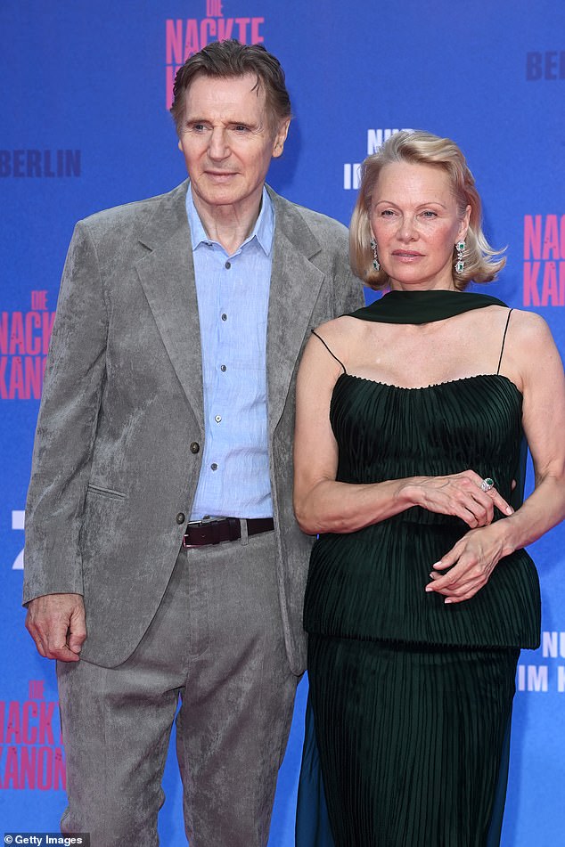 Pamela looked incredibly elegant in an emerald green gown and chic scarf while Liam cut a dapper figure in a grey suit