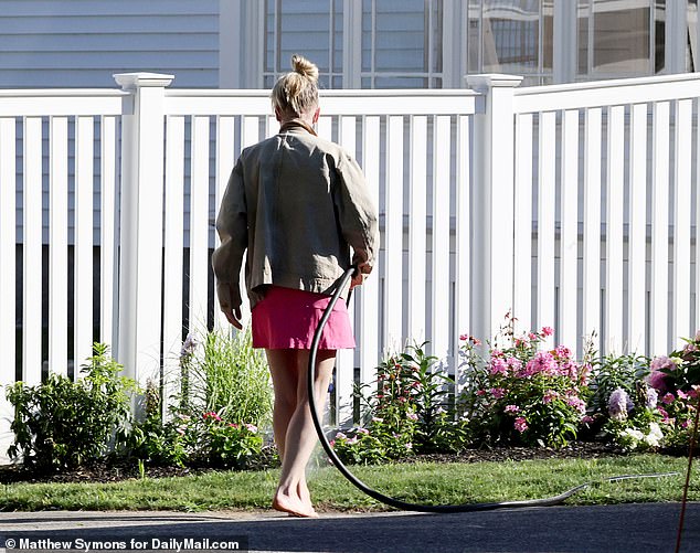 Despite being at the center of a very public cheating scandal, she appeared stoic, dressed in a pink matching gym set and light jacket, with her hair up in a messy bun