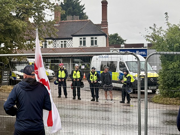 Later in the evening a line of police officers stood inside the protective fence in a bid to protect The Bell Hotel from protestors