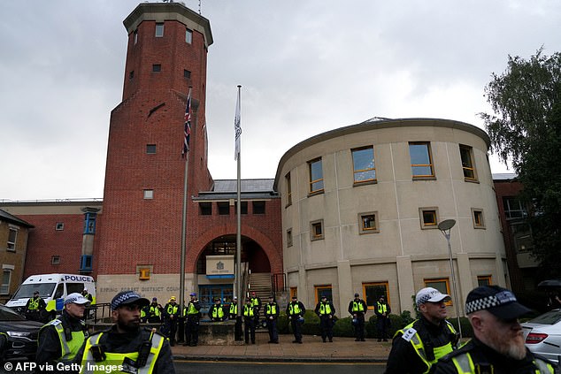 Officers line the streets outside Epping Forest District Council before protesters arrived ahead of the council meeting
