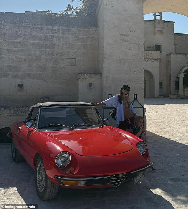 Another image was taken as Ratajkowski paused next to a vintage red car outside what appeared to be a scenic hotel