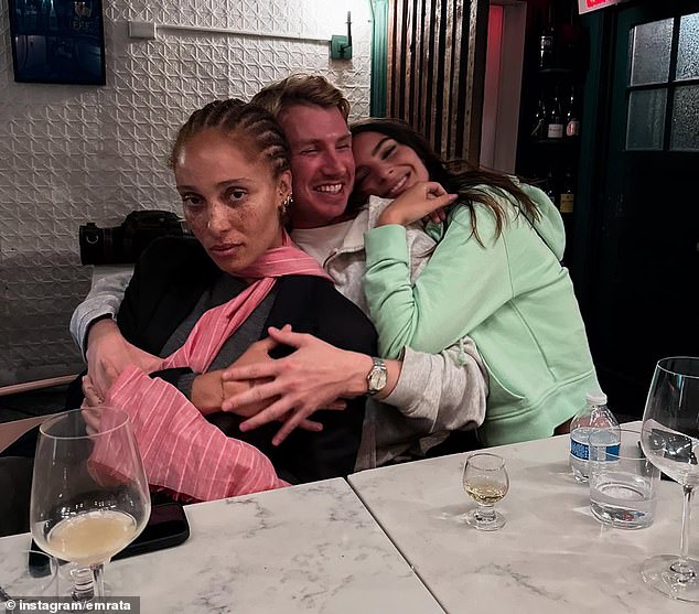 The model was also seen flashing a cheerful smile as she paused for a photo with pals as they enjoyed dinner together