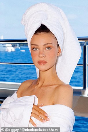 The model slipped into a white hotel bathrobe and hair towel as she posed for photos, similar to Victoria's post in June