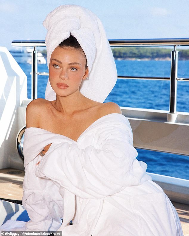 Nicola looked incredible as she posed completely naked under a bathrobe during her luxury yacht trip