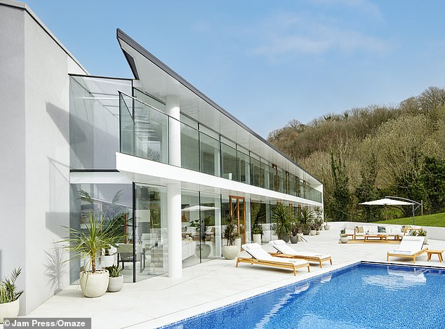 The modern Devon Omaze house with an infinity pool, compared to James Bond's lair
