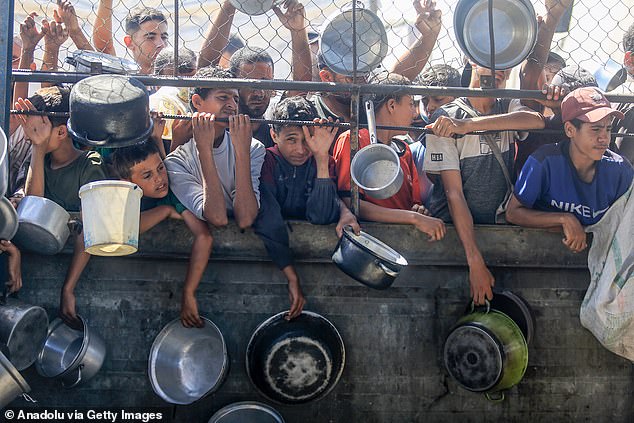 Palestinians gather to receive food in Khan Yunis, Gaza, amid shortages of aid