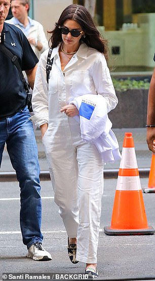 She accessorized the look for the busy day of filming with small, gold-hooped earrings as well as flashy gold necklaces