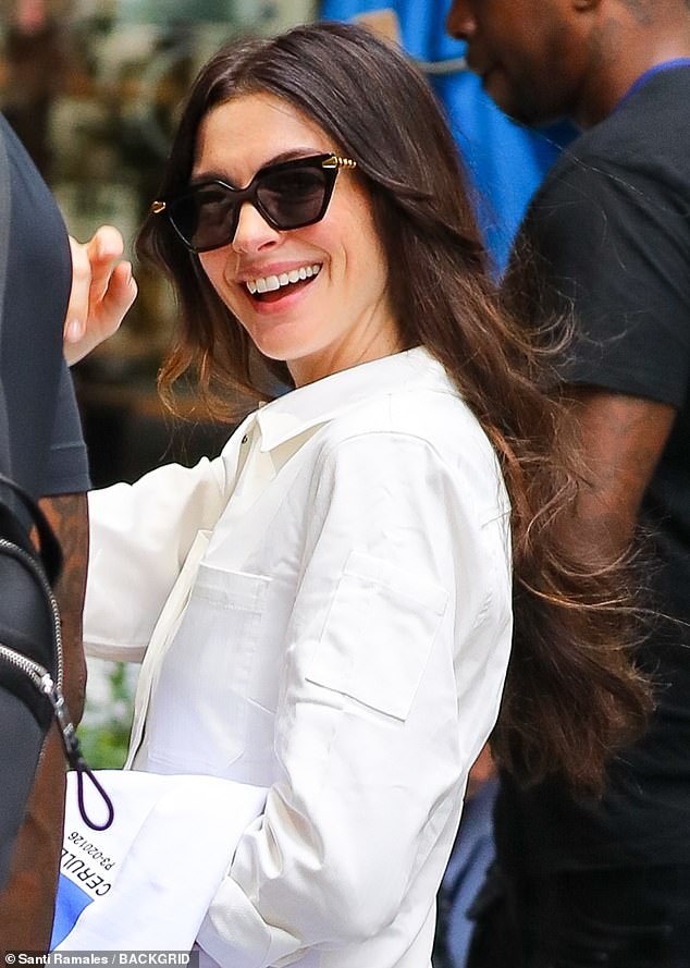 Hathaway flashed a cheerful smile as she greeted nearby fans