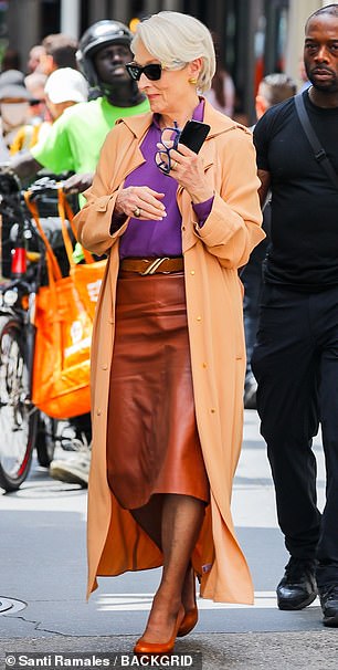 The Death Becomes Her actress layered the ensemble with a tan trench coat and slipped into a pair of closed-toed, brown pumps