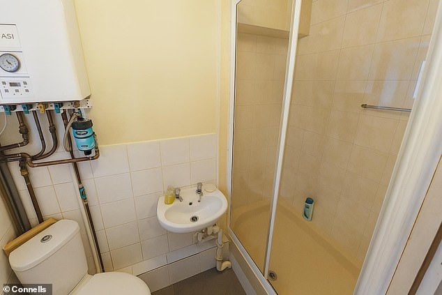 A photograph of one of two shower rooms features odd details, such as an unreadable shampoo bottle - a sign of AI image generation