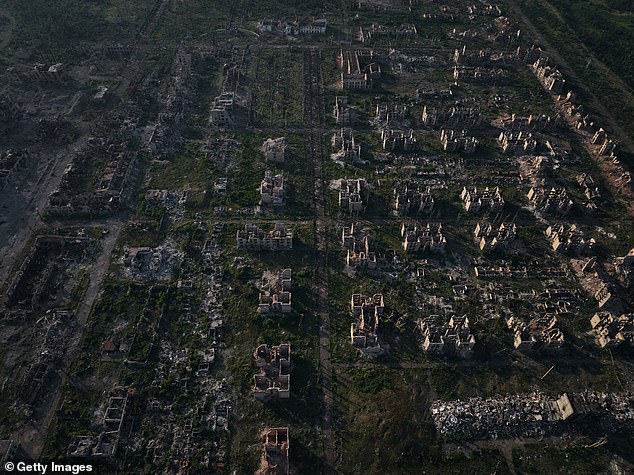 The ruins of destroyed buildings are seen in the city of Chasiv Yar at dawn on July 24