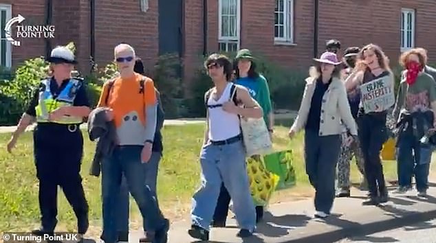 The protest in Aldershot was arranged by Turning Point UK, which was demonstrating against the migrant hotel in the Hampshire town (pictured are counter protesters being escorted)