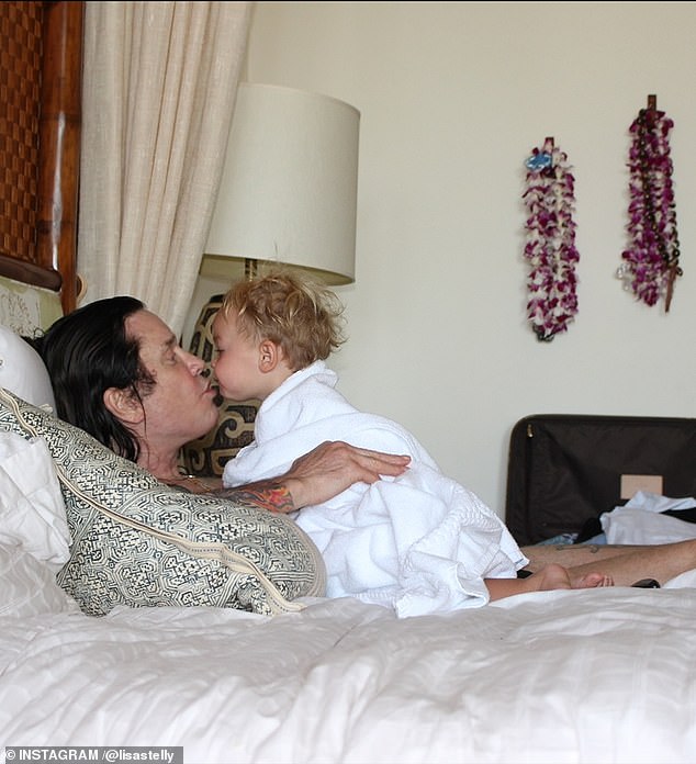 In an older snap, he cooed at one of his grandkids while resting on a bed as she looked ready to plant a kiss on his face