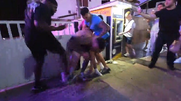 Sullivan then unleashes a flurry of punches against the group of men