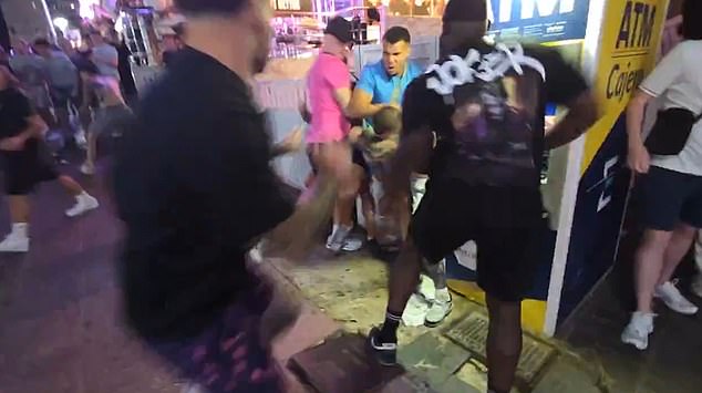 A crowd of bystanders formed around them as the fight continued
