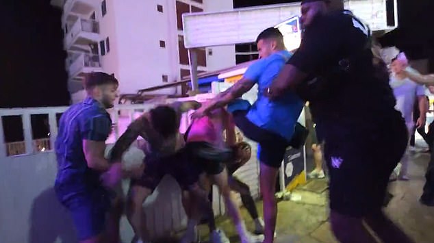 Sullivan is shown forcefully punching a man  then knocking another to the ground