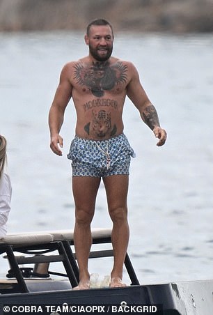 Conor showed off his muscular and tattooed frame as he went shirtless in a pair of blue swimming trunks, before stripping down to his boxers