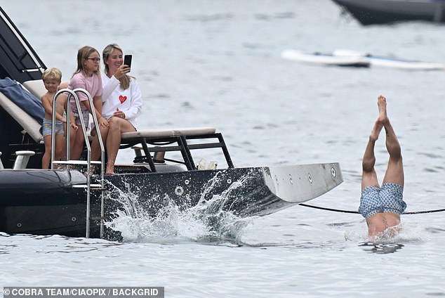 The children were impressed by their dad, with the older boys jumping into the water after him