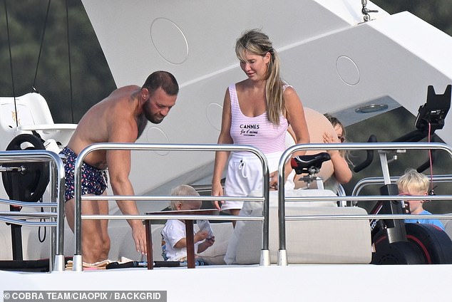 Dee wore a plunging pink swimsuit with white shorts over the top while filming Conor from the boat