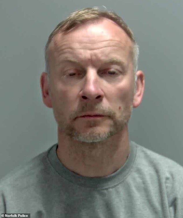 Creak glares at the camera as his mugshot is taken at a police station after he was arrested for 'repeatedly' knifing his former wife