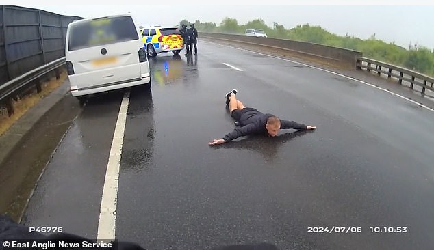 The suspect is ordered to lie on the ground with his arms outstretched and legs crossed as officers approach him with cuffs
