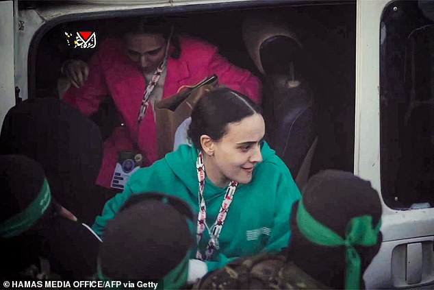 Emily smiles defiantly at her captors as she is released during a handover process as part of a ceasefire deal