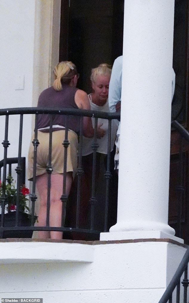 At one point, the unidentified woman appeared to steady Sky with a hand pressed to her chest, helping her stay upright as she was visibly overcome with emotion