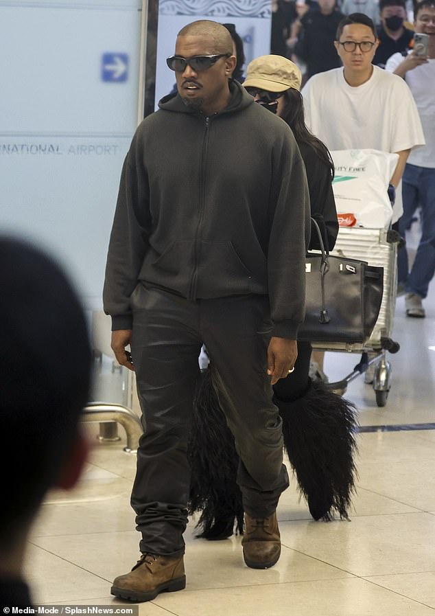 The rapper's look closely mirrored his wife's all-black attire