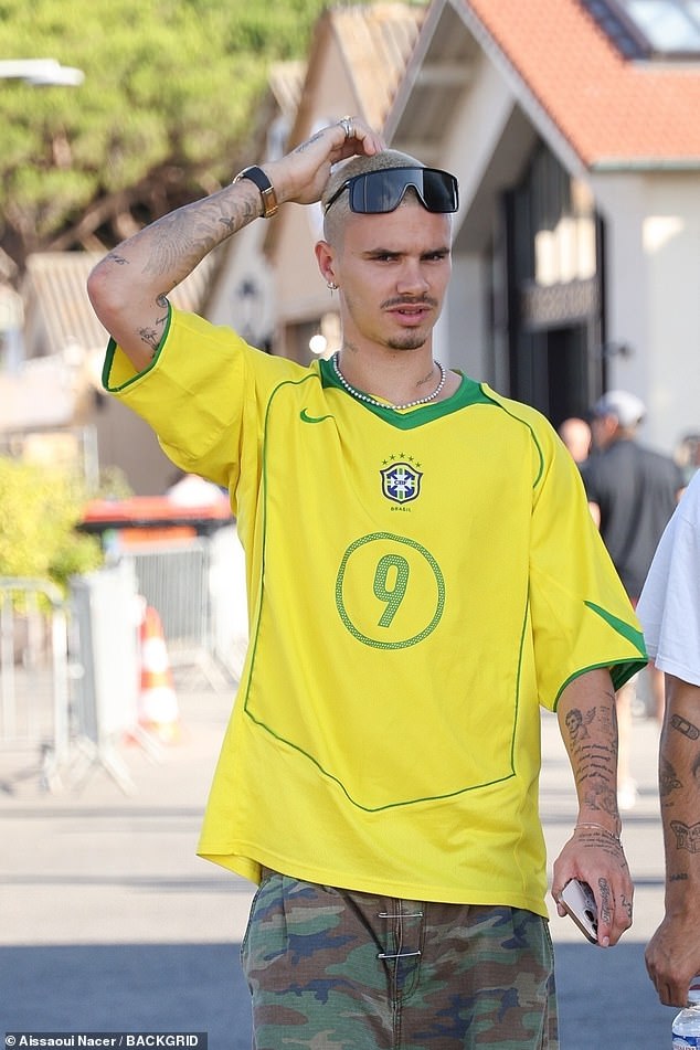 He cut a stylish figure in a vintage Brazil Ronaldo football jersey