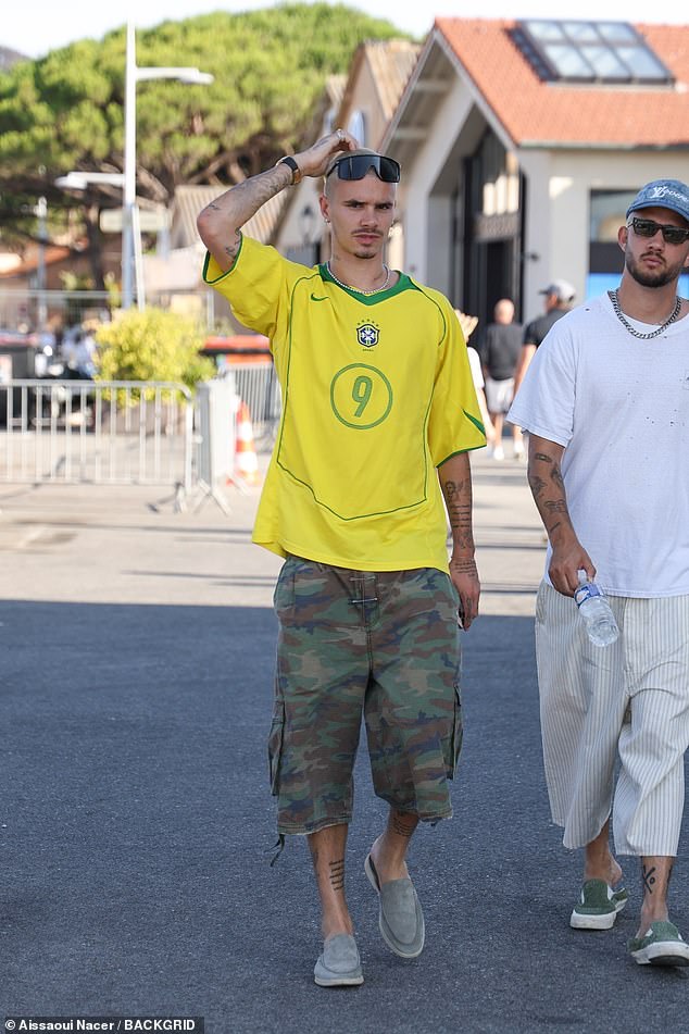 He teamed the top with camo-print shorts and suede loafers