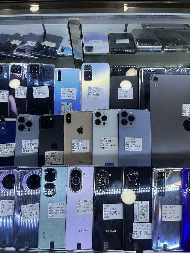 Second-hand phones can be seen for sale in China, including several recent iPhone models
