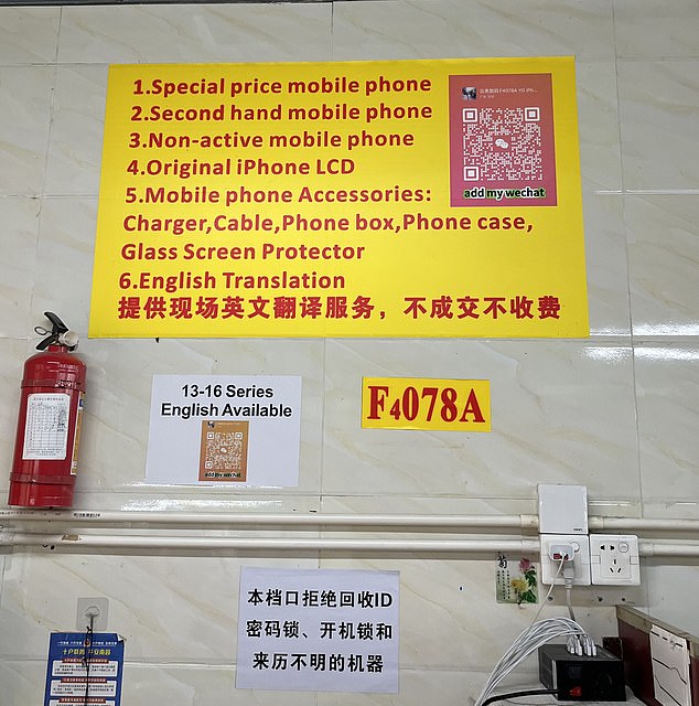 A sign in a phone shop in China lists the array of products available, including iPhones