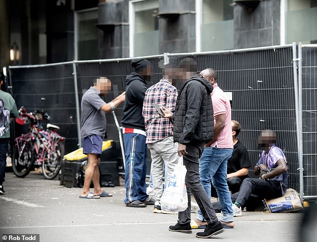 Migrants outside The Thistle Central Hotel in Islington where many residents have been charged with criminal offences