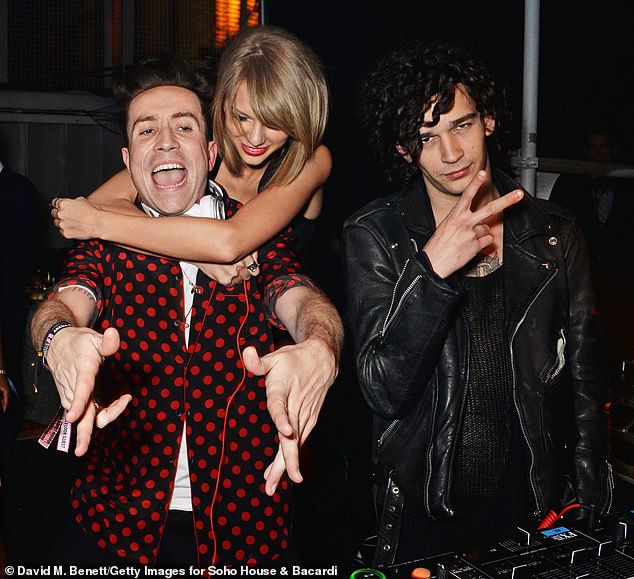 Swift is pictured with Nick Grimshaw (left) and Healy (right) in 2015 in London. She reportedly met Healy when she attended a 1975 show in Los Angeles in November 2014